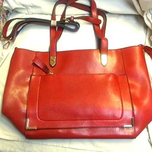 This is a beautiful maroon color handbag.